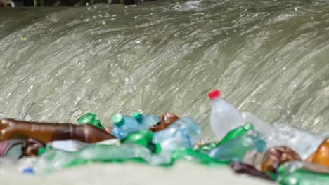 ranger pick up water into the plastic bottle from the river at the jungle closeup ranger pick up water into the plastic bottle from the river at the jungle closeup