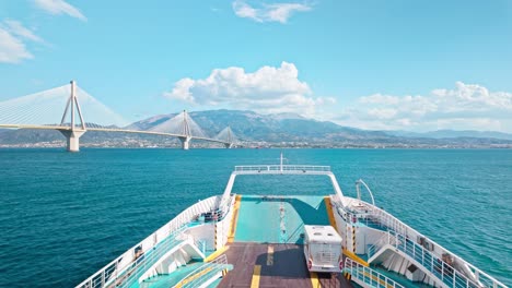 ferry approaching rio-antirio bridge in greece