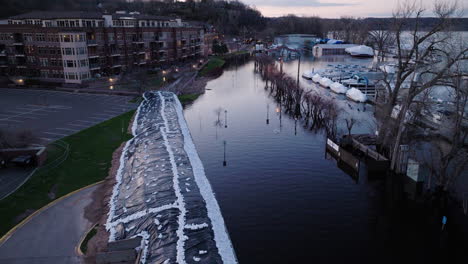 sandbag barrier preventing river water from flooding residents property in city during natural disaster