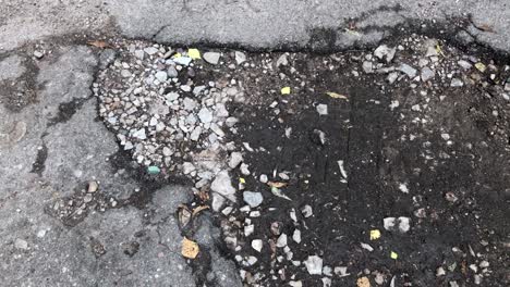 damaged asphalt road with potholes