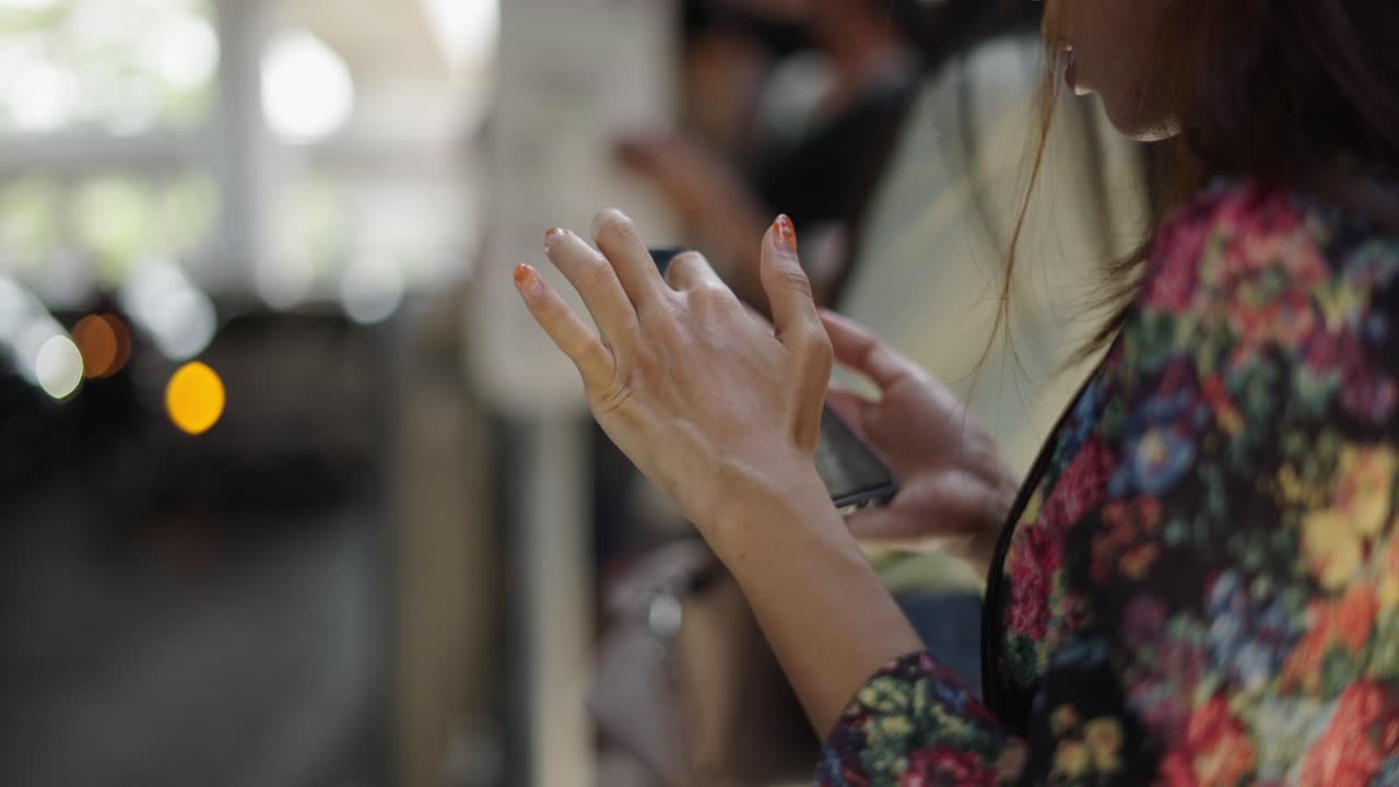 Close-up of a person using a smartphone outdoors
