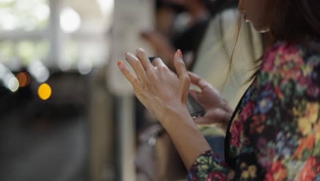 close-up of a person using a smartphone outdoors