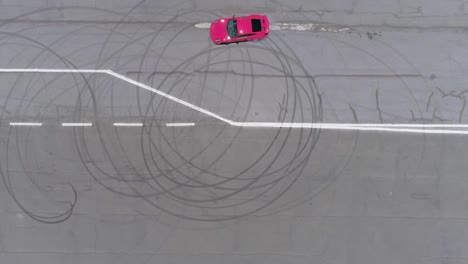 aerial view of a racing car going in circles on a race track.