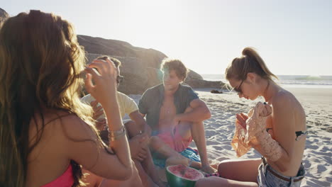 multi ethnic  group of friends on the beach hanging out