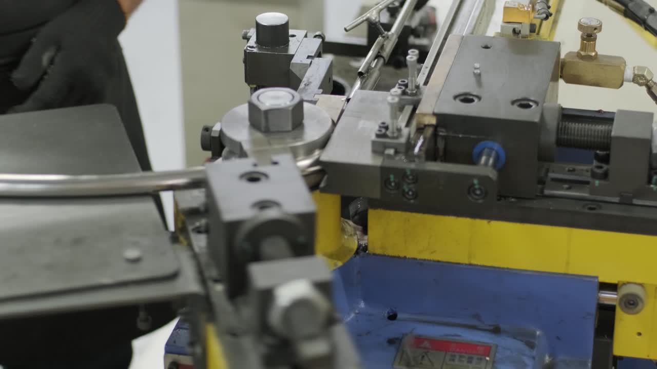 Industrial bender equipment machine for metal pipe bending in the factory. Automatic metalworking machine for electronic turning metal pipe and cold bending at industrial hall at manufacturing plant