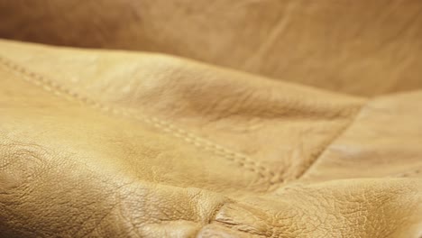 brown leather fashion jacket texture with stitched seams slide shot