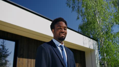 businessman in front of a modern house