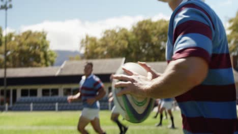 rugby player running while holding oval ball 4k