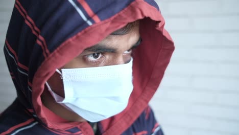 person wearing a mask and a hoodie