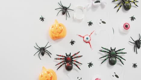 Close-up-of-multiple-halloween-toys-and-candies-on-white-background