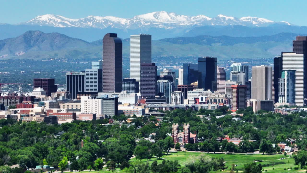 Downtown Denver aerial drone City Park cityscape Nuggets Avalanche Rockies Rocky Mountains snow Mount Evans best cinematic original parallax foothills Colorado spring summer green lush to right