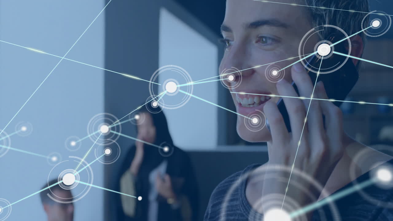 Using phone with digital network animation, person smiling in office setting