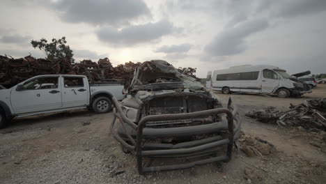 wide shot of destroyed pickup truck at the vehicle lot memorial, tkuma israel after hamas attack