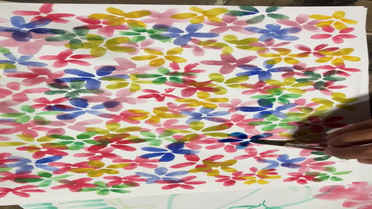 Close up learning painting colorful abstract flowers using watercolors and brushes on paper