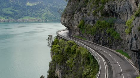 scenic winding road along cliffside lake