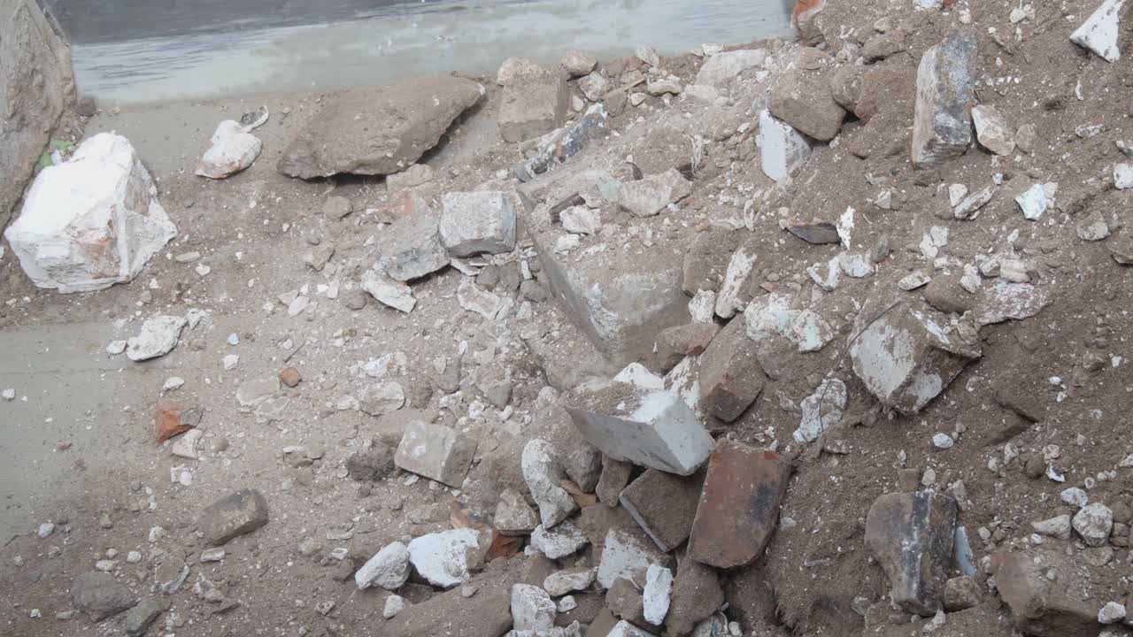 Excavator With Bucket Loads Construction Brick Scrap To The Truck