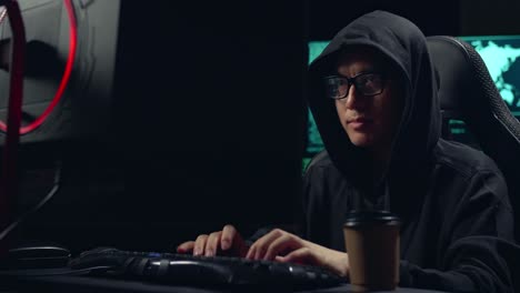 Asian Male Hacker Using Computer Hacking