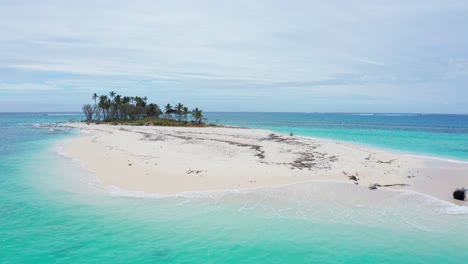 drone shot, small uninhabited coral island with white sand and palm trees, tonga polynesia