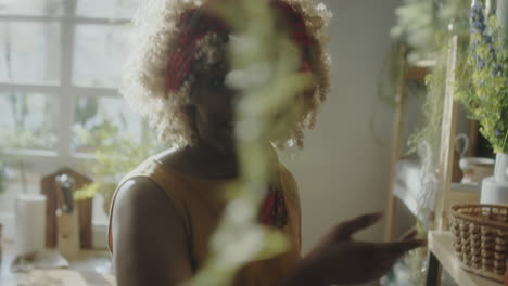 woman baking in a cozy kitchen with plants