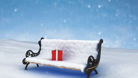 animation of snow falling over christmas present on bench covered in snow in winter scenery