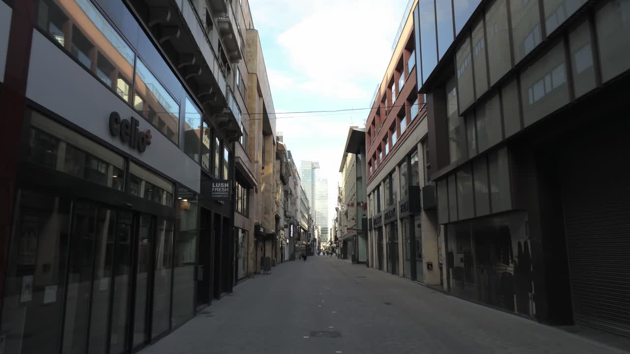 Rue Neuve, Brussels, Belgium. April third 2020. Corona Virus Lockdown, walking along empty famous shopping street. Ghost Town. Forward tracking shot.