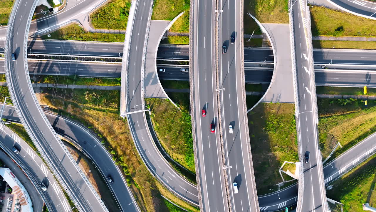 Complex road interchange in urban area. Aerial view of a busy road interchange with multiple lanes and vehicles navigating the intricate pathways