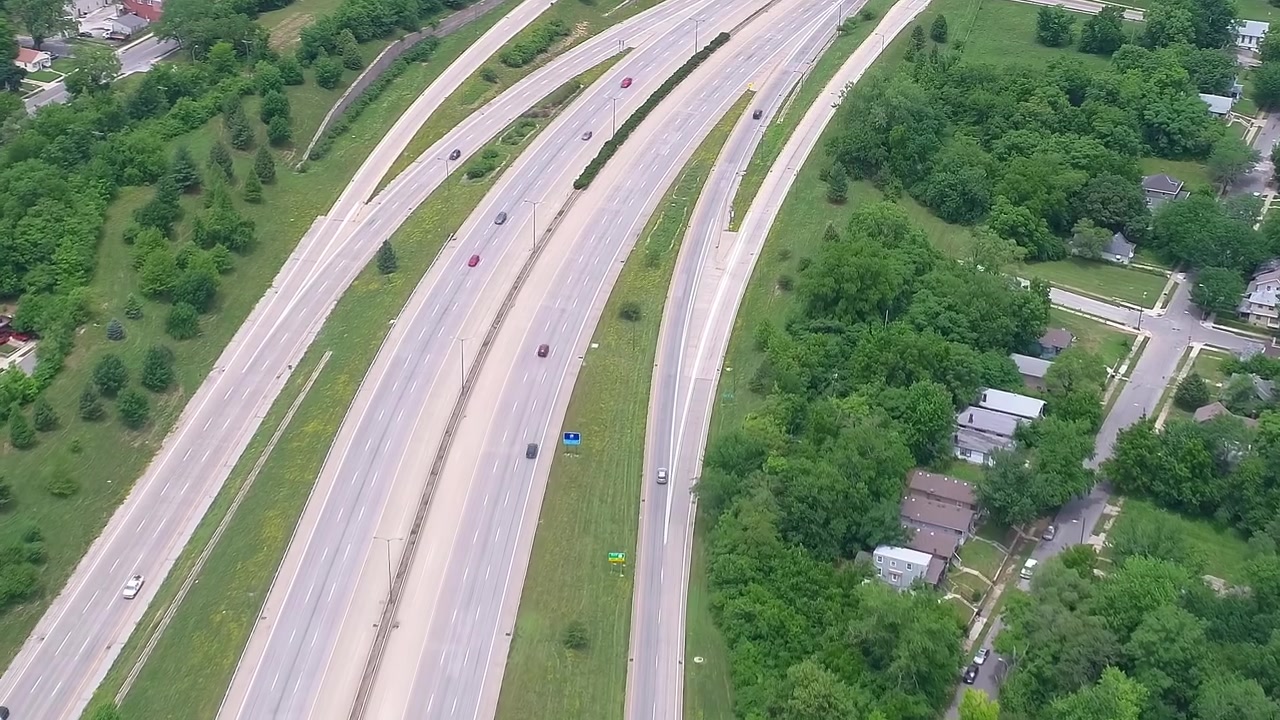 Traffic flows on a highway surrounded by trees in the USA