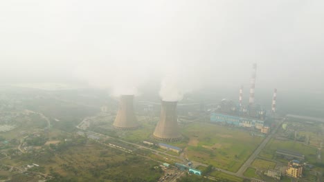 industrial aerial drone shot in india, with smoke plumes rising into the sky from large factories.