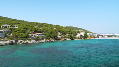 wide view of agistri island port, as seen from departing ferry boat