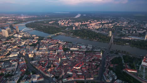 aerial revealing shot of downtown bratislava and the stunning castle, in slovakia