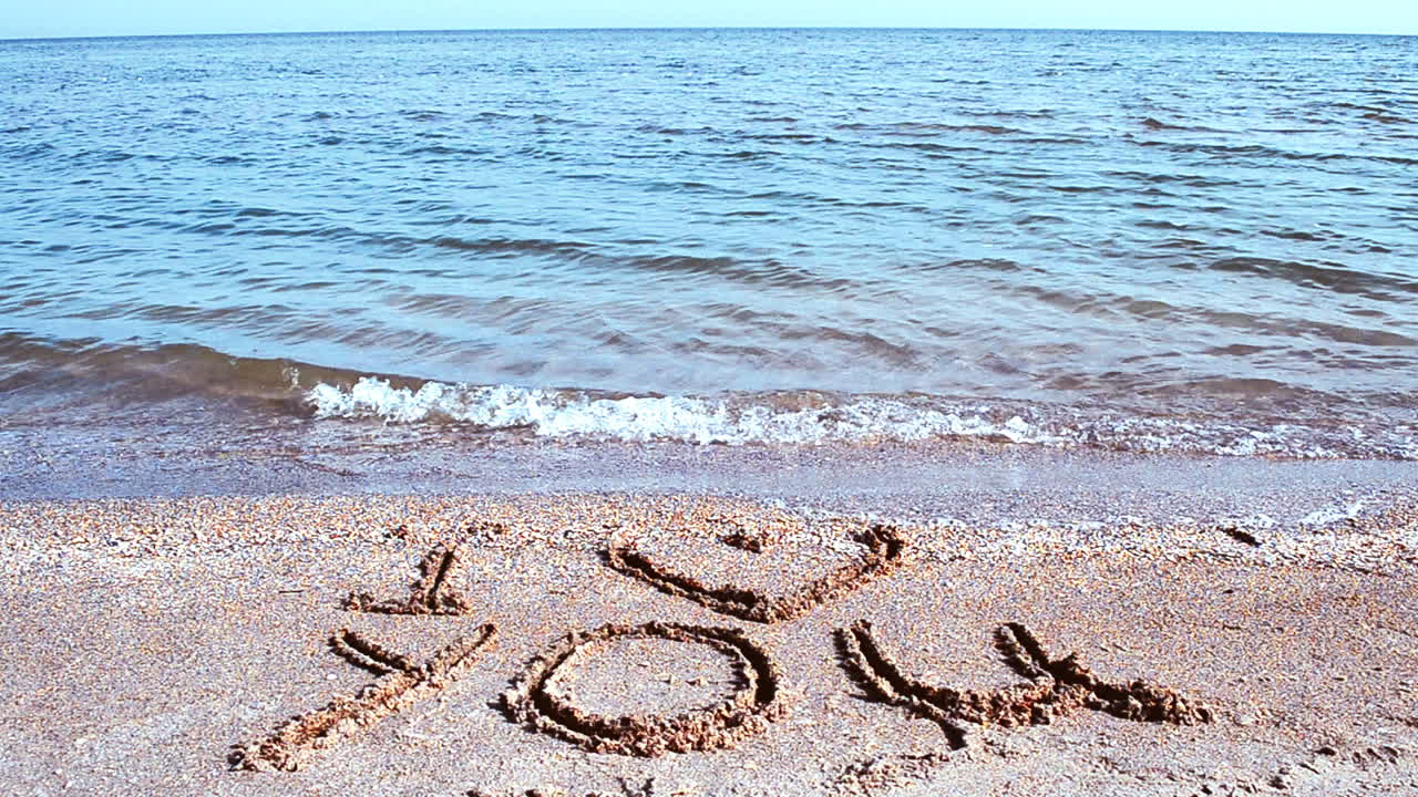 Inscription I love you on sand. Shooting on the beach