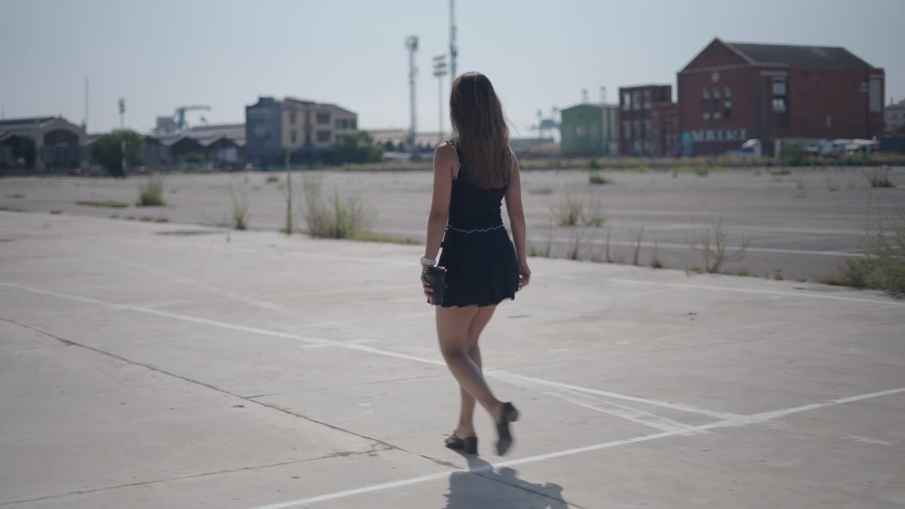 Woman Walking in Empty Urban Parking Lot