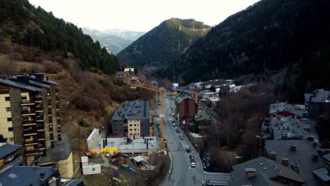 flying over a road mountain valley surrounded by trees approaching yellow crane