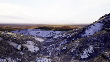 Majestic landscape of rolling hills under a serene sky at dawn