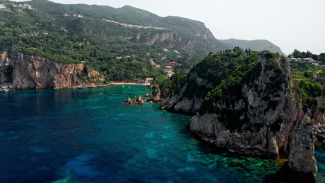 Aerial-drone-shot-over-the-picturesque-rocky-coastline-of-Paleokastritsa-bay-in-Corfu,-Greece