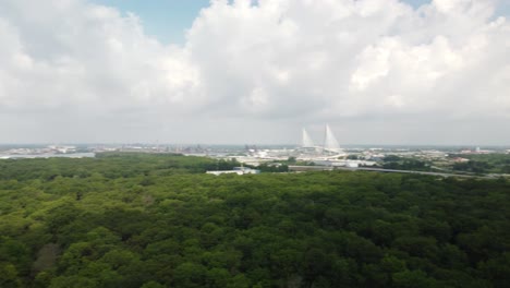 4k drone panoramic of dense clouds over obijway park forest, windsor ontario