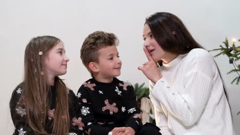 family sharing a quiet moment or secret during the christmas holidays