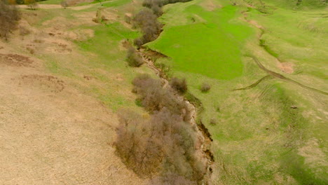 aerial view of a mountain valley with lush green pasture