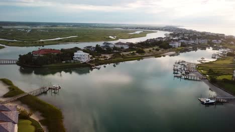 early morning sunrise drone flyover of inner harbor and marsh wetlands on figure eight island in wilmington north carolina