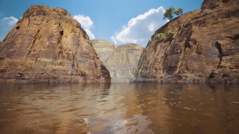 majestic natural rock formations reflected in calm water beneath a blue sky