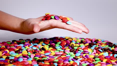 hands interacting with colorful candy pieces