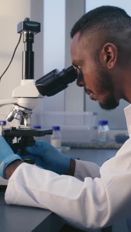 scientist using a microscope in a laboratory setting