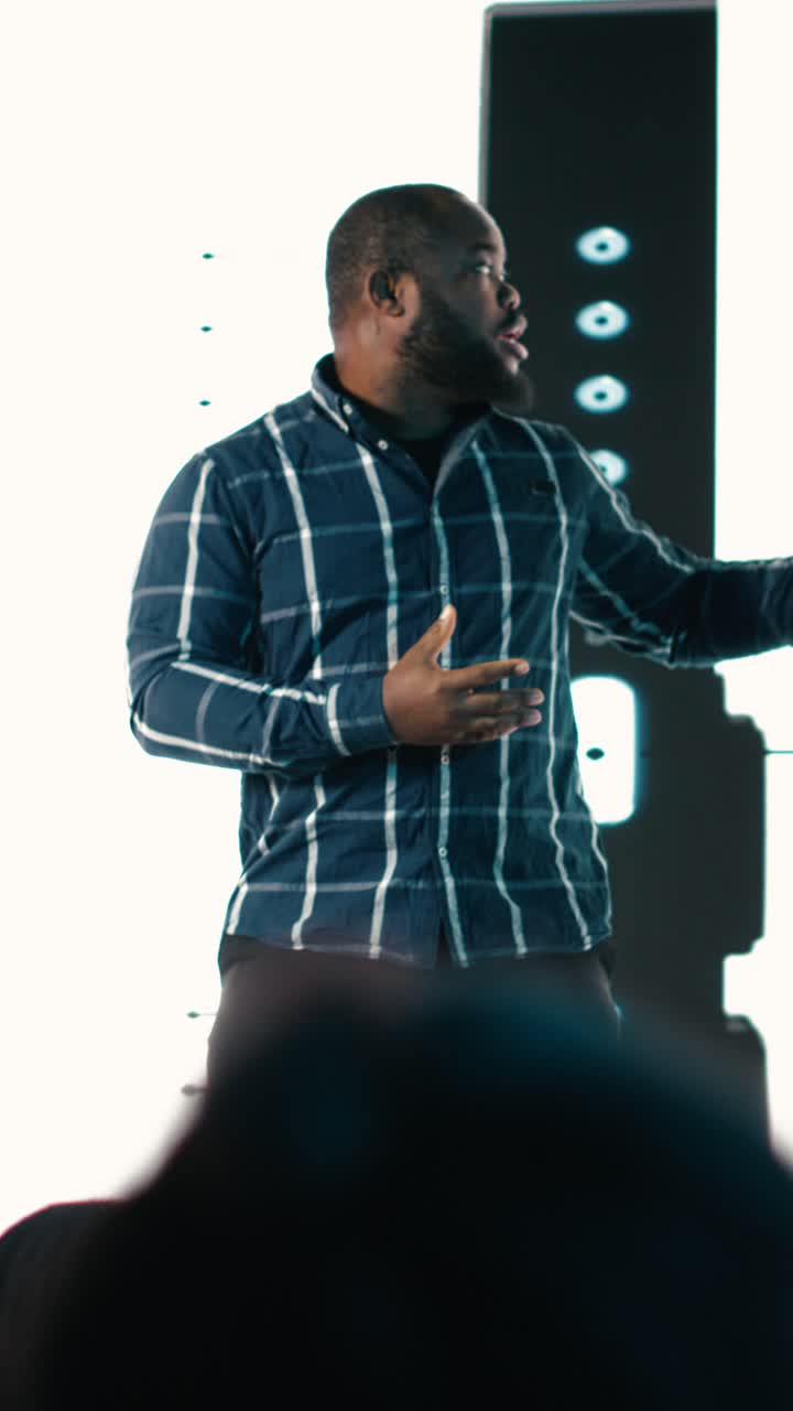 Vertical Video Black senior designer introduces new smartphone to participants