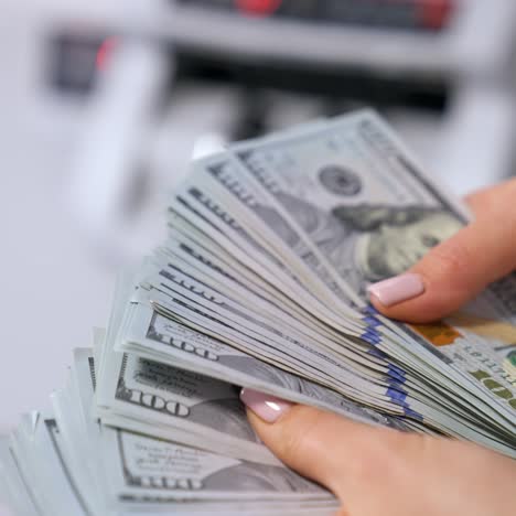 female hands counting us dollar bills. us national paper currency