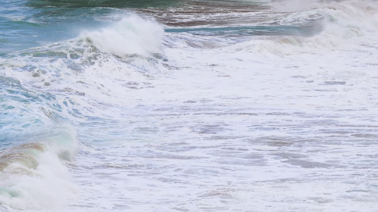 Dynamic ocean waves crash against the shore at Port Campbell, captured in natural light with a steady camera
