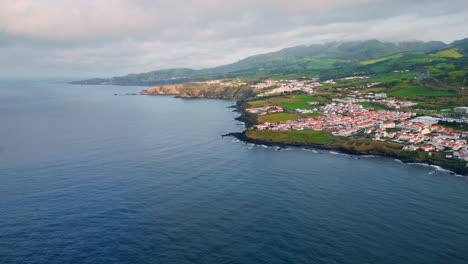 morning seaside village landscape aerial shot. drone flying beautiful coastline