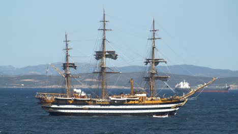 Establisher-view-of-beautiful-Tallship-of-Amerigo-Vespucci-off-coast-of-Sardinia