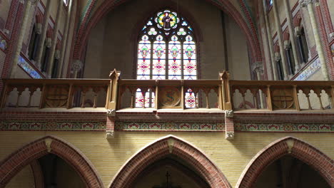 ribbed vault interior design with a stained glass window at the center of gouwekerk in gouda, netherlands