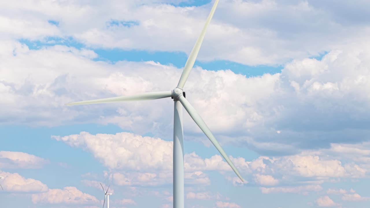 Close-up footage of windmill blades rotating smoothly above mountain slopes. Captured in central Bulgaria for a strong eco-power message