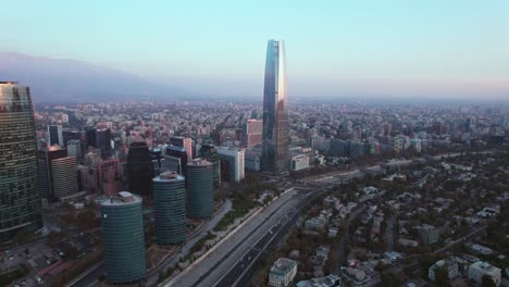 slow aerial dolly towards the costanera tower within the financial district at sunset